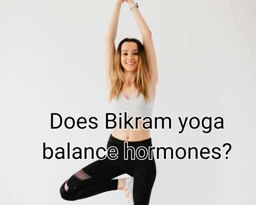 Bikram yoga pose held gracefully by a focused woman.